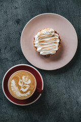 Lemon tartlet and a cup of cappuccino. Top view