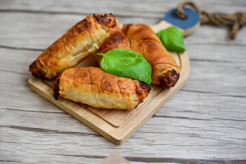  Greek style Mini filo pastry rolls with bacon and cheddar cheese .Home made bakery .Fresh baked  Mini cheese  ,meat and herbs puff pastries