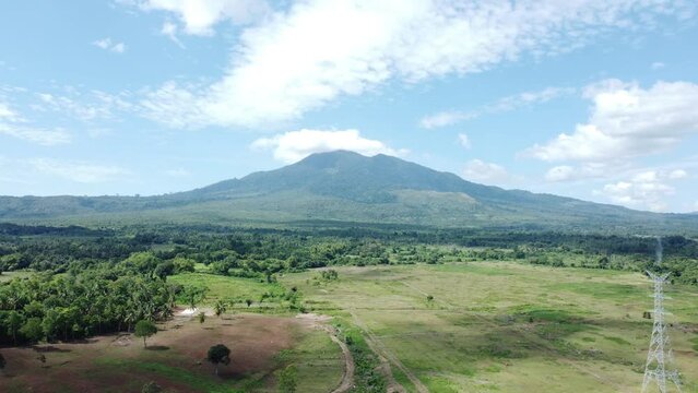 The view from the drone of Mount Seulawah Agam, green expanse of grass and trees.