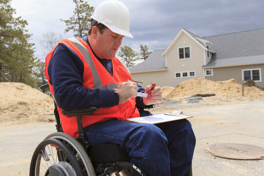 Construction engineer with spinal cord injury adjusting vise tool on site