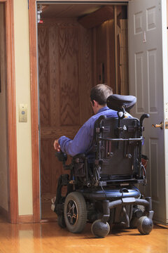 Man with Cerebral Palsy entering a home elevator