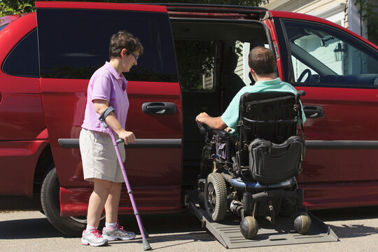 Couple with Cerebral Palsy getting into an adaptive vehicle