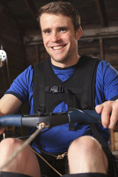 Man with spinal cord injury using his rowing machine