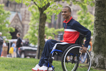 Man in wheelchair who had  Spinal Meningitis moving independently in the city