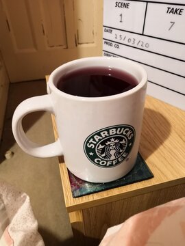Large Starbucks mug with vimto on bedside table