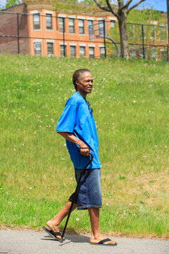 Man with Traumatic Brain Injury taking a walk with his cane