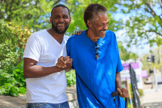 Man with Traumatic Brain Injury with cane enjoying his friend