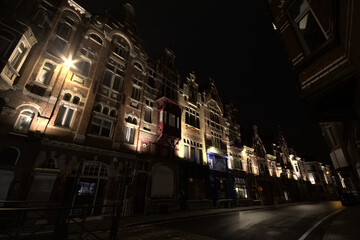 Fototapeta na wymiar Illuminated 19th century houses in eclectic style, , at night in the famous Baudelo street in Ghent, 28 January 2021 