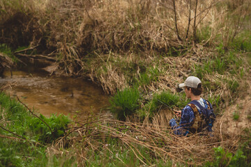 Young Man fishing in creek