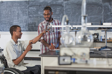 Two students who had Spinal Meningitis studying acceleration on a frictionless table in laboratory