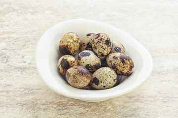 Raw quail eggs heap in the bowl