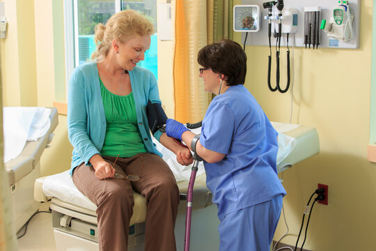Nurse with Cerebral Palsy taking a patient's blood pressure in a clinic