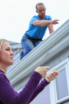 Homeowner and roofer communicating in American Sign Language about 'Replace' and 'Right there'