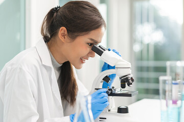 Medical development research laboratory, science young woman scientist in glasses, glove looking...