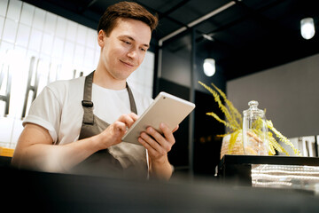 A male employee has his own small business coffee shop. A startup entrepreneur works in the...