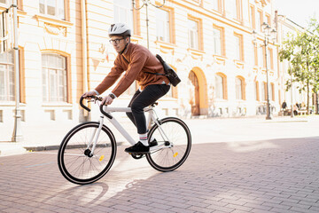 Fototapeta A man rides a bicycle to work, an eco-transport for people and a clean city. obraz