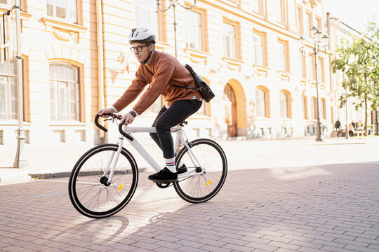 A man rides a bicycle to work, an eco-transport for people and a clean city.