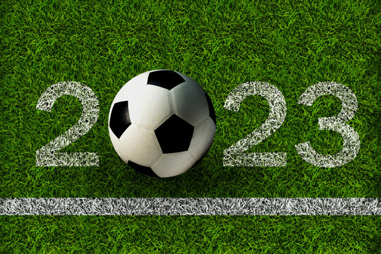 Top view of soccer ball on soccer field with number 2023. Tournament concept.