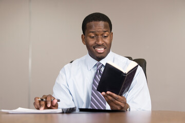 A business man reading in an office.