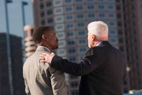 Older businessman mentoring a younger businessman