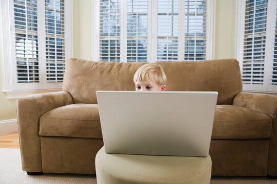 A boy using a laptop.