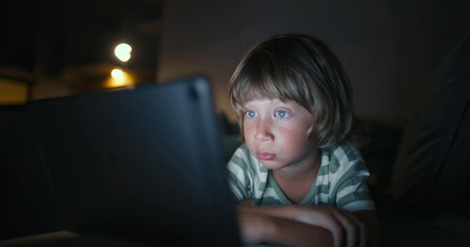 Close up boy 4-5 years afraid child using tablet in living room, Small child hold pad computer surfing not safe content online internet at home concept safety parental security child on social media