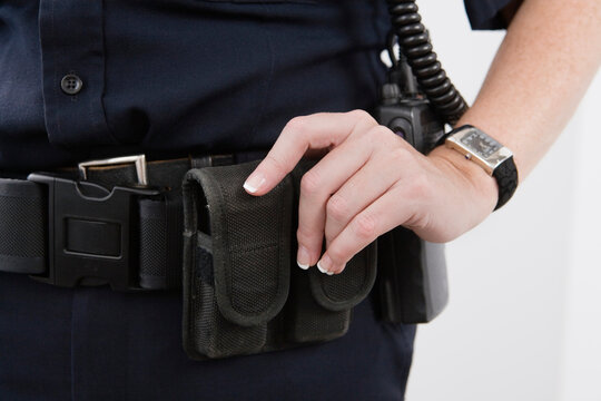 Close up of pouches on a cop's waist belt.