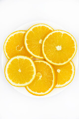 Sliced orange slices on a white plate. Orange slices on a white background. Oranges close-up.