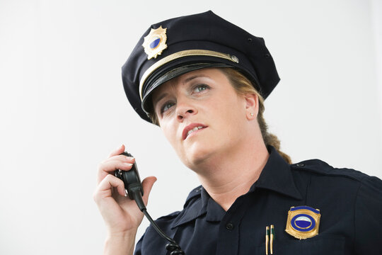 Woman police officer talking on hand mike.