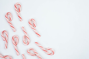 top view, Border of red and white candy canes on white background