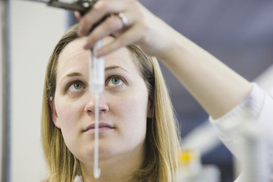 Female scientist checking automatic titrator