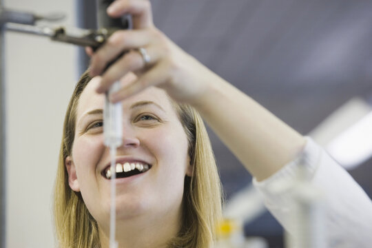 Female scientist checking automatic titrator
