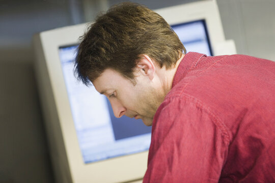 Close-up of a mid adult man working in a control room