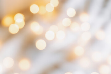 Yellow bokeh effect on a light background. Bokeh background from a garland. Abstract Blurred Christmas Lights Bokeh Background