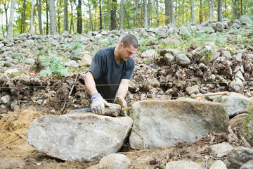 Man building stone wall