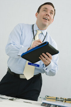 Businessman writing on a notepad