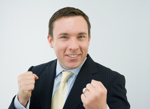 Portrait of a businessman clenching his fists and smiling