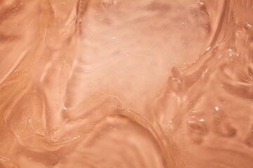 Liquid orange cosmetic smudge cream gel background 