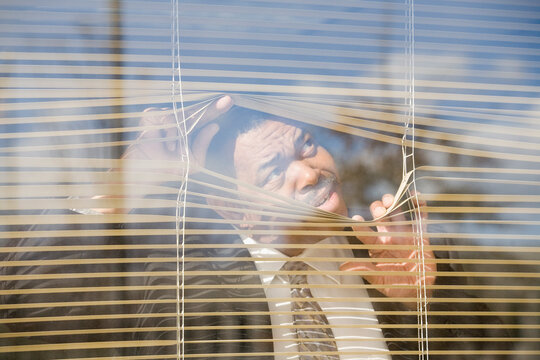 Close-up of a businessman looking through a window