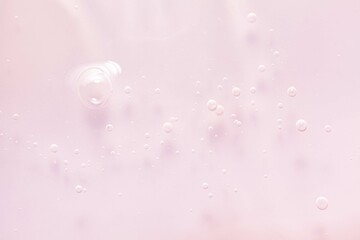 Cosmetic light pink transparent texture. Serum or shower gel, shampoo background