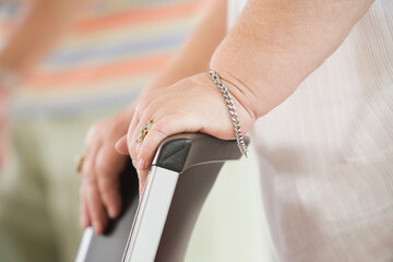 Close-up of a senior woman's hands exercising with a chair in an exercise class