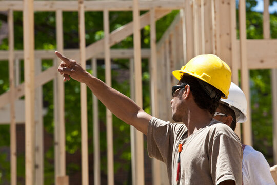 Carpenters planning at a construction site