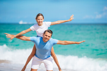 Family of dad and daughter have fun together on the beach