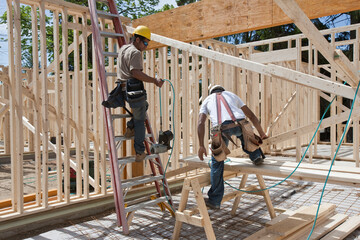 Carpenters framing a house