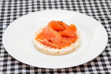 Tasty Rice Cake Sandwich with Fresh Salmon Slices on White Plate. Easy Breakfast and Diet Food. Crispbread with Red Fish. Healthy Dietary Snack