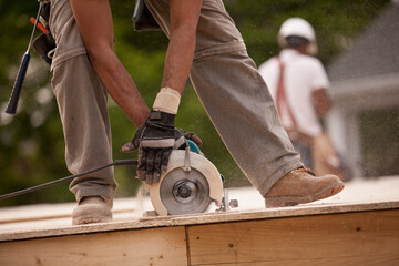 Carpenter sawing a board