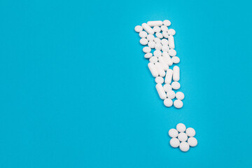 Global Pharmaceutical Industry and Medicinal Products - Exclamation Point Made from White Pills and Tablets Lying on Blue Background