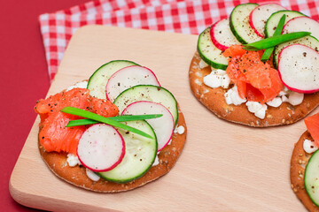 Crispy Cracker Sandwiches with Fresh Salmon, Cucumber, Radish, Cottage Cheese and Green Onions. Easy Breakfast. Quick and Healthy Sandwiches. Crispbread with Tasty Filling. Healthy Dietary Snack