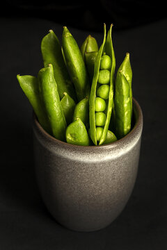 Pot with pea pods in studio