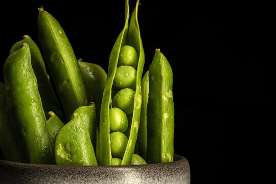 Pot with pea pods in studio
